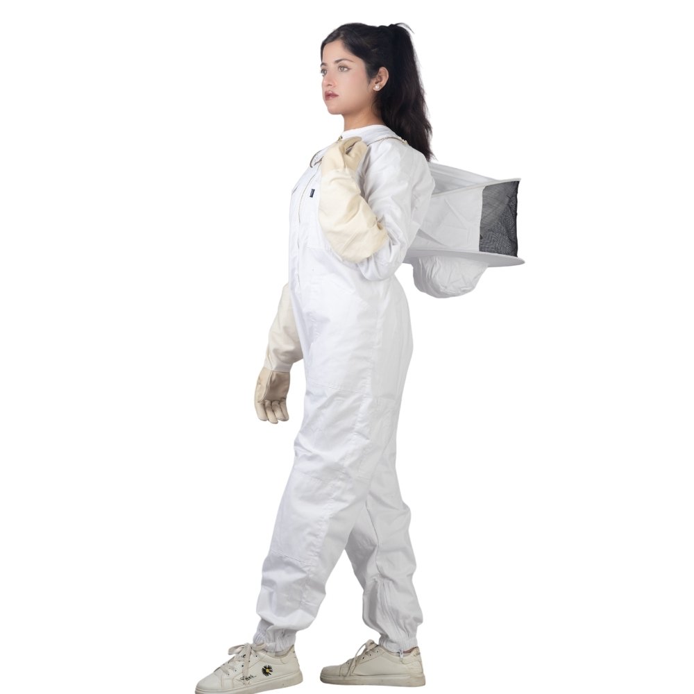 Side angle view of white cotton beesuit with protective veil and gloves for beekeeping