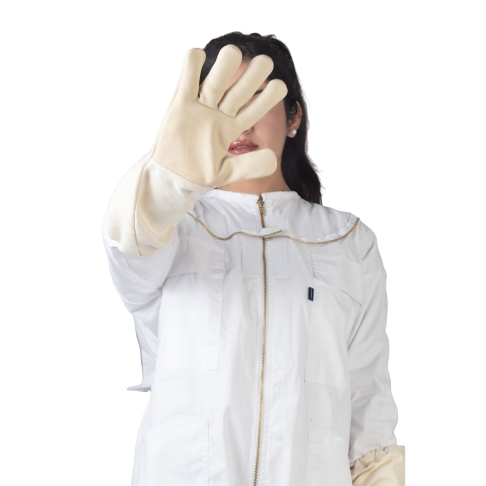 Close-up of protective gloves on white cotton beesuit for safe beekeeping