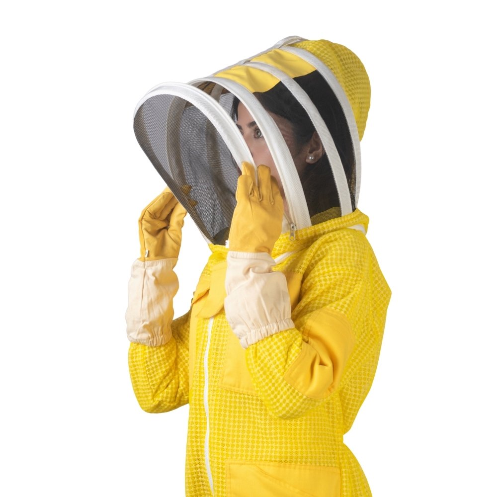 Side close-up view of yellow beesuit showing beekeeper opening protective mesh veil with gloves